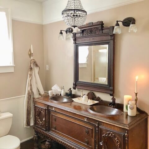 a large bathroom with a restored vanity with two copper sinks