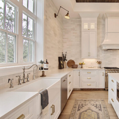 a white kitchen with fireclay sink