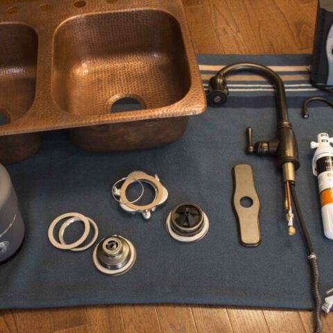 a copper sink and all the parts to install it