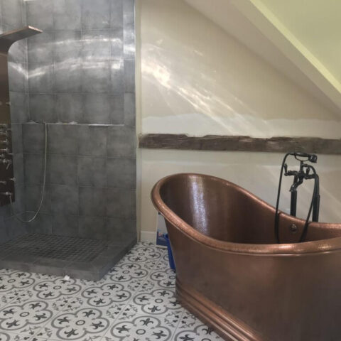 a copper tub in a master bathroom