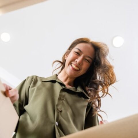 a happy person opening a box