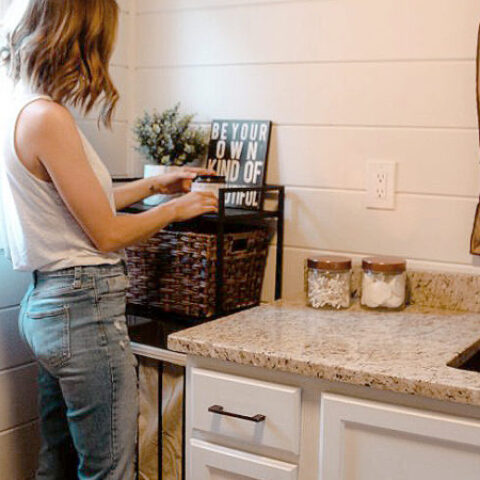 person decorating a farmhouse bathroom