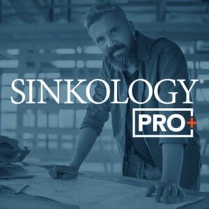Colorized image of general contractor on a construction site leaning on table reviewing plans with the Sinkology Pro+ logo overlaid.